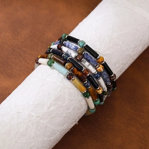 Detail view of handmade multilayer beaded bracelets with colorful natural stones and Czech beads