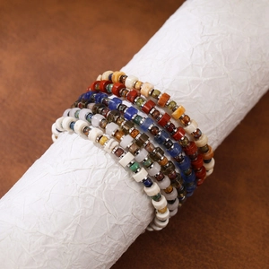 Close-up of bohemian multi-layer natural stone bracelets with Czech beads and metal spacers