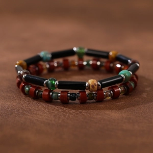 Macro view of handmade stone bracelets with vintage beads on a brown leather surface