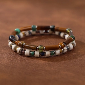 Handmade natural stone beaded bracelets with Czech glass beads on brown leather background