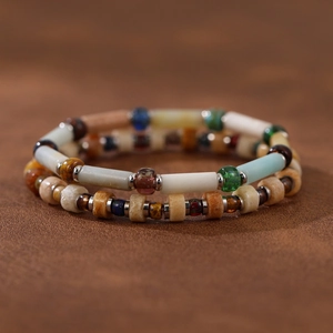 Macro detail of handmade bohemian beaded bracelets featuring natural stone and glass beads