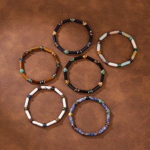 Detailed view of six natural stone beaded bracelets with metallic spacer beads on leather