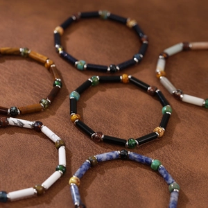 Detailed close-up of handmade natural stone beaded bracelets with various earthy gemstones