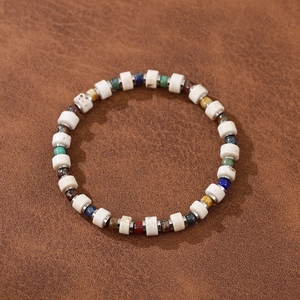 Detail of bohemian handmade beaded bracelet with colorful stones and Czech beads on leather