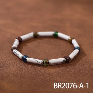 Detail of handmade beaded bracelet with marble texture stones and colorful Czech beads