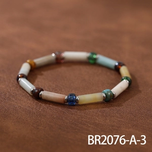 Macro detail of handmade bohemian bracelet with multicolored natural stones on leather