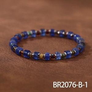Close-up of handmade beaded bracelet with blue cylinder stones and vintage metal spacers