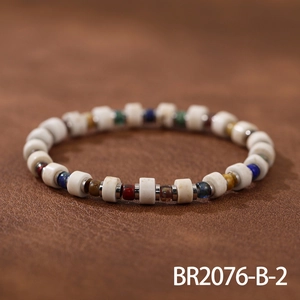 Detail shot of a handmade beaded bracelet with colorful natural stones on leather background