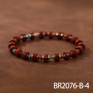 Detailed shot of handmade woven bracelet with red jasper stones and colorful Czech beads