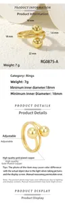 Detail view of adjustable gold-plated copper ring with dual ball design and specifications