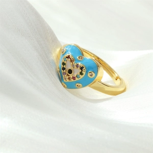 Detailed close-up of heart-shaped evil eye ring with colorful enamel and crystals