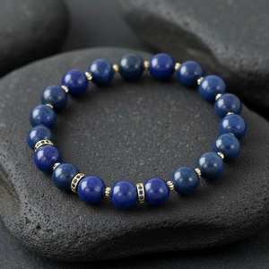 Lapis lazuli semi-precious stone beaded bracelet with gold spacers for elegant style.