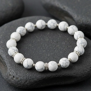 White marble beaded bracelet detail showcasing sparkling rhinestone spacer beads and elastic band.