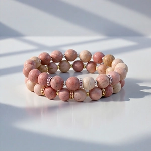 Close-up detail view of double strand natural stone beaded bracelet with metallic spacer accents.