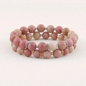 Close-up detail view of double-layer semi-precious pink stone beaded bracelet with sparkling metal spacers.