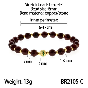 Detail showing 6mm garnet beads with golden spacers and emerald-set hollow bead charm