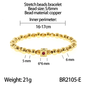 Detail of 16-17cm gold beaded stretch bracelet with textured copper beads and red stone