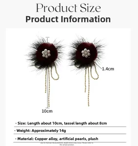 Detailed view of burgundy plush flower earrings with pearl centers and gold bead tassels