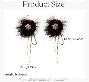Detail view of plush flower earrings with white pearls and long golden bead chain tassels
