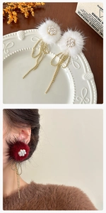 Detail of plush fur ball earrings with pearl flower and long golden bead tassels