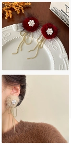 Detail of plush fur ball earrings with pearl flower clusters and gold fringe tassels