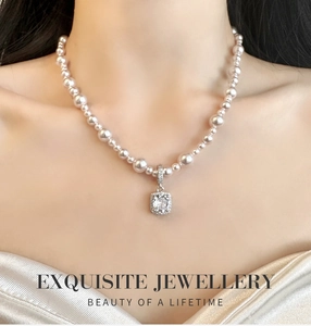 Exquisite pearl necklace with a large square cut crystal pendant on an elegant model