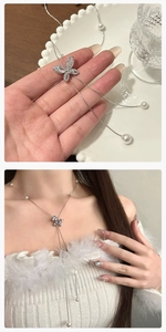 Detailansicht der Schmetterling-Lariat-Kette mit Zirkonia und Perlenanhängern