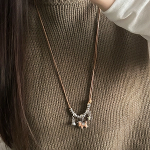 Vintage wooden rocking horse pendant necklace with metal star and beads on brown cord