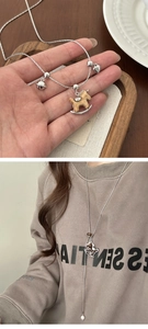 Dettaglio della collana maglione cavallo in legno con catena argento e cuori