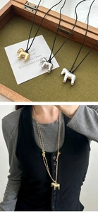 Polished abstract pony pendant shown in gold and silver finish on various necklace cords