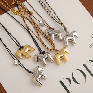 Unique horse and flower pendant necklace with elegant metallic finish on a long cord