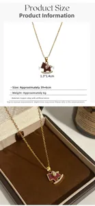 Detailed view of rocking horse pendant with burgundy enamel and cubic zirconia stones