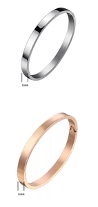 Detail view of 6mm wide brushed titanium steel bangles in silver and rose gold finishes
