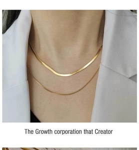 Détail d'un collier double épaisseur en maille serpent dorée porté par un mannequin