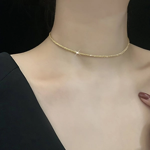 Minimalist sparkling titanium steel gold choker necklace on model's neck for elegant look