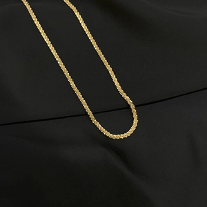Minimalist gold titanium steel necklace with sparkling popcorn chain texture on black fabric