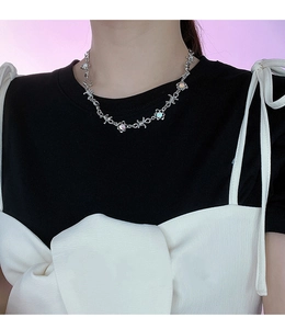 Dettaglio della collana a catena di spine con pietre di luna su una modella