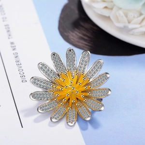 Exquisite silver flower brooch with sparkling cubic zirconia and golden stamen detail
