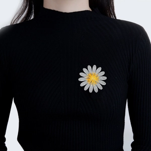 Elegant silver daisy brooch with sparkling zircons on black sweater for women