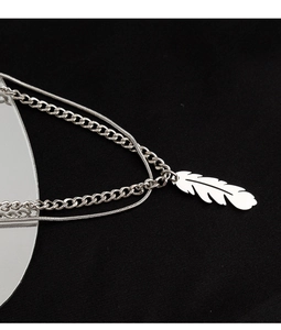 Detailed view of double-layer titanium steel necklace with feather pendant and snake chain