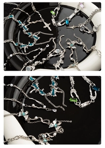 Detail of silver liquid metal necklace with cross, emerald crystals and pearls