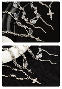 Detailed macro view of silver titanium necklace with blue opal cross and star pendants
