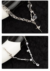 Detail of silver layered necklace with pearls moonstone star and water drop pendants