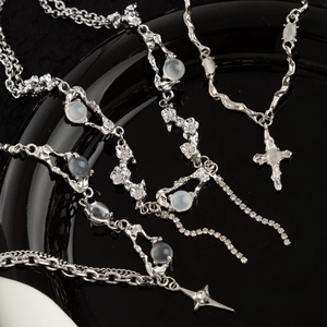 Titanium steel butterfly cross necklace with pearl tassels and light blue moonstone pendant