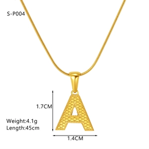 Macro shot of gold letter A pendant with grain texture and sleek snake chain