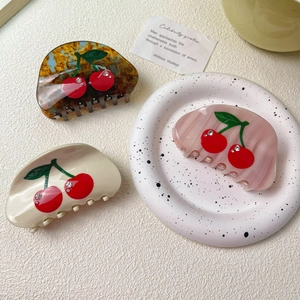Set of three acetate cherry hair claws with rhinestones in amber, beige, and pink marble