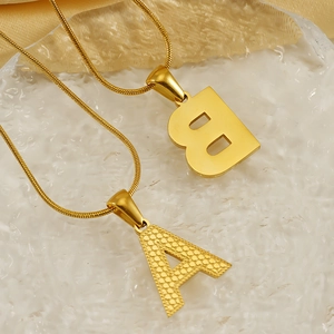 Fashionable gold initial pendant necklaces A and B with snake chains and textured finish