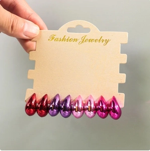 Detail of colorful waterdrop earrings set in red, pink, and purple with metallic finish