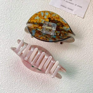 Detail of tortoise shell and pink gradient acetate claw clips with metal spring mechanism