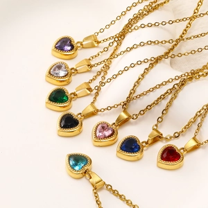 Close-up of heart-shaped zircon necklaces in multiple colors with golden chains